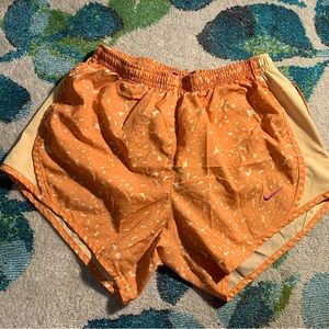 Orange with white spots nike runner shorts. Size large. Has a liner inside.